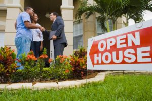 Real Estate Agent Greeting Couple at Open House | First-Time Homeowners
