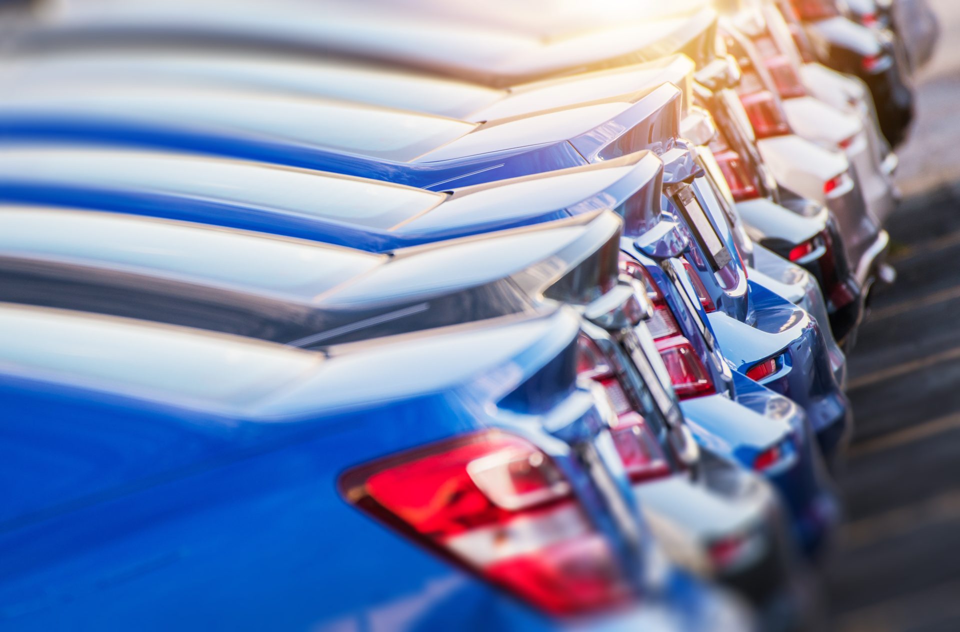 row of new vehicles at dealer